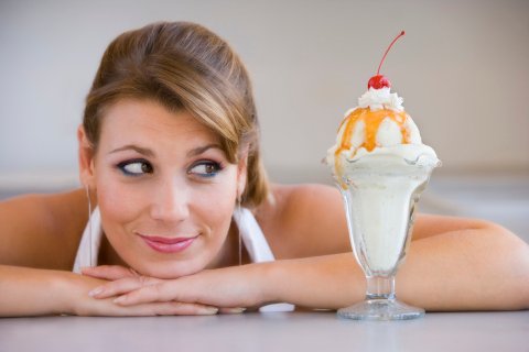 Woman looking at ice-cream sundae.